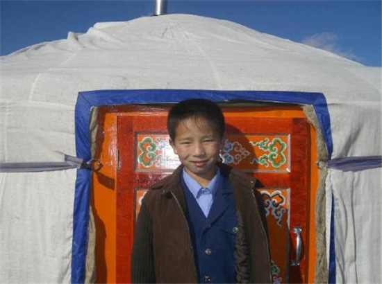 A young man in front of his new home. Source: Christina Noble Children’s Foundation