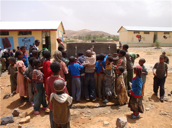 Students enjoy drinking water. Source: A Glimmer of Hope