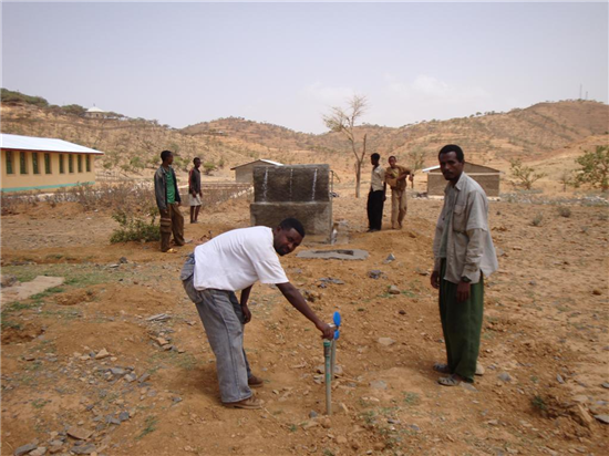 Construction and burial of the pipe that goes from the well to the school. Source: A Glimmer of Hope