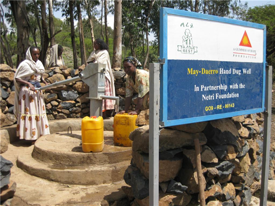 Poster indicating the participation of the Netri Foundation in the construction of a well. Source: A Glimmer of Hope