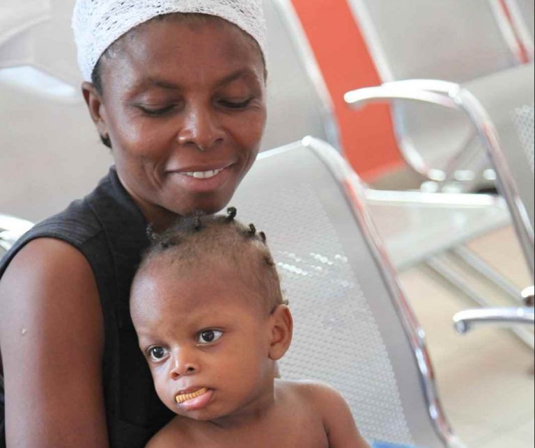 A mother and her son enjoy cookies from the bakery. Source: Our Little Brothers Foundation