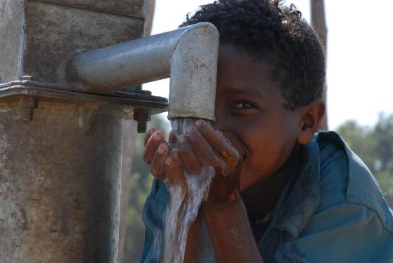 A boy drinks from one of the wells in Dembia, Ethiopia. Source: A Glimmer of Hope