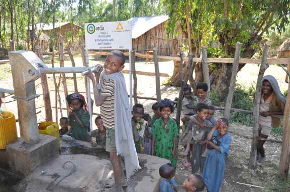 Children enjoy using the well. Source: A Glimmer of Hope