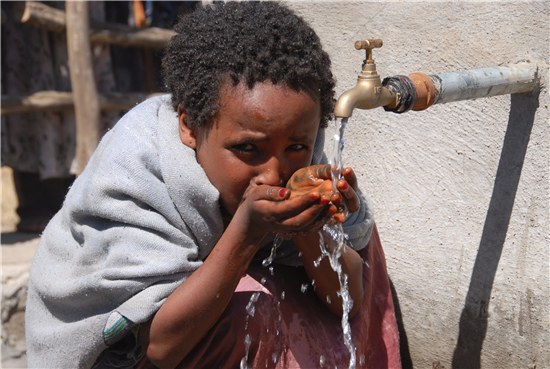 A young girl drinks from a fountain in Tigray. Source: A Glimmer of Hope  