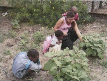 Children helping in the garden. Source: IBO Foundation