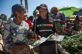 M-KOPA representative showing the solar energy system. Source: M-KOPA Kenya