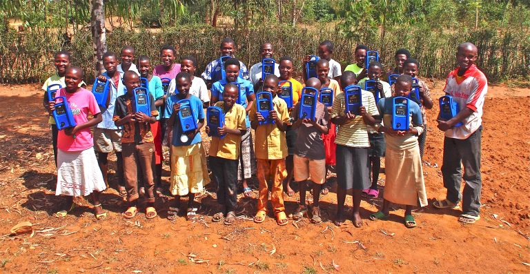 A group of beneficiaries receives training on the use of radios. Source: Lifeline Energy