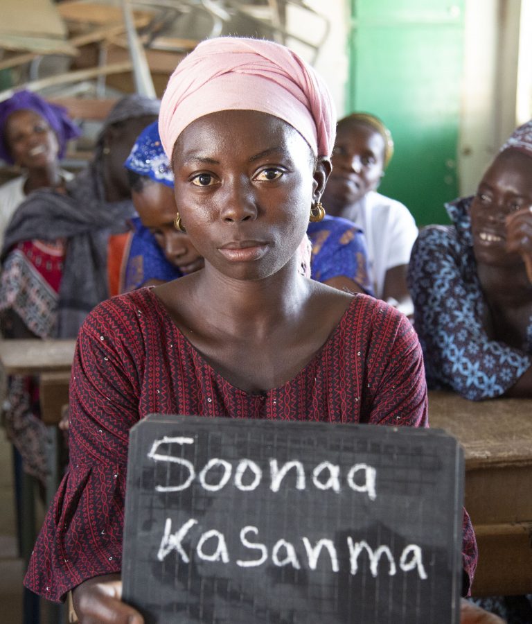 Woman learning to write her name. Source: Guné Foundation