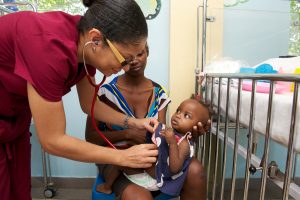 Female doctor with patient in the malnutrition room. Source: NPH