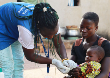 Health worker vaccinates a child in Binah. Source: Integrate Health