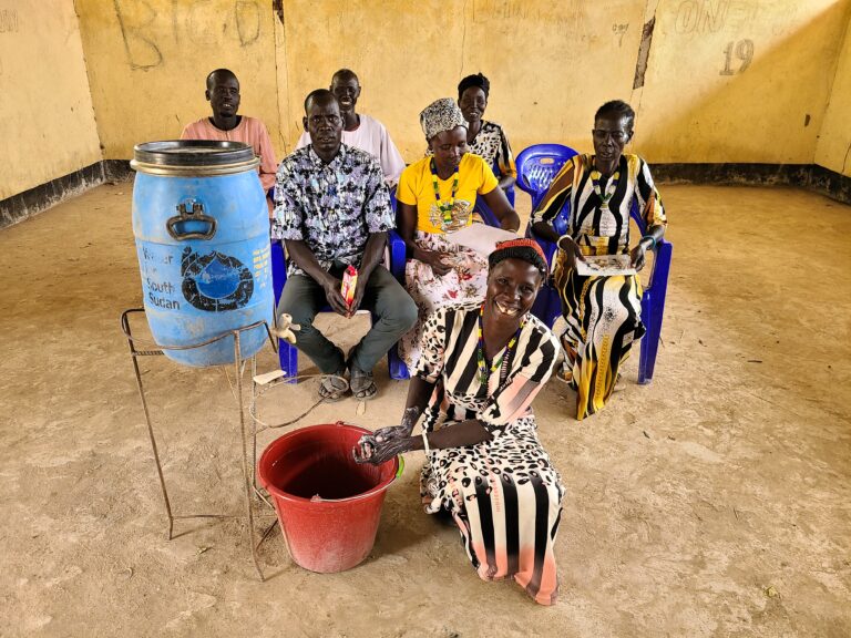 A woman practises handwashing as part of hygiene training. Source: Water for South Sudan
